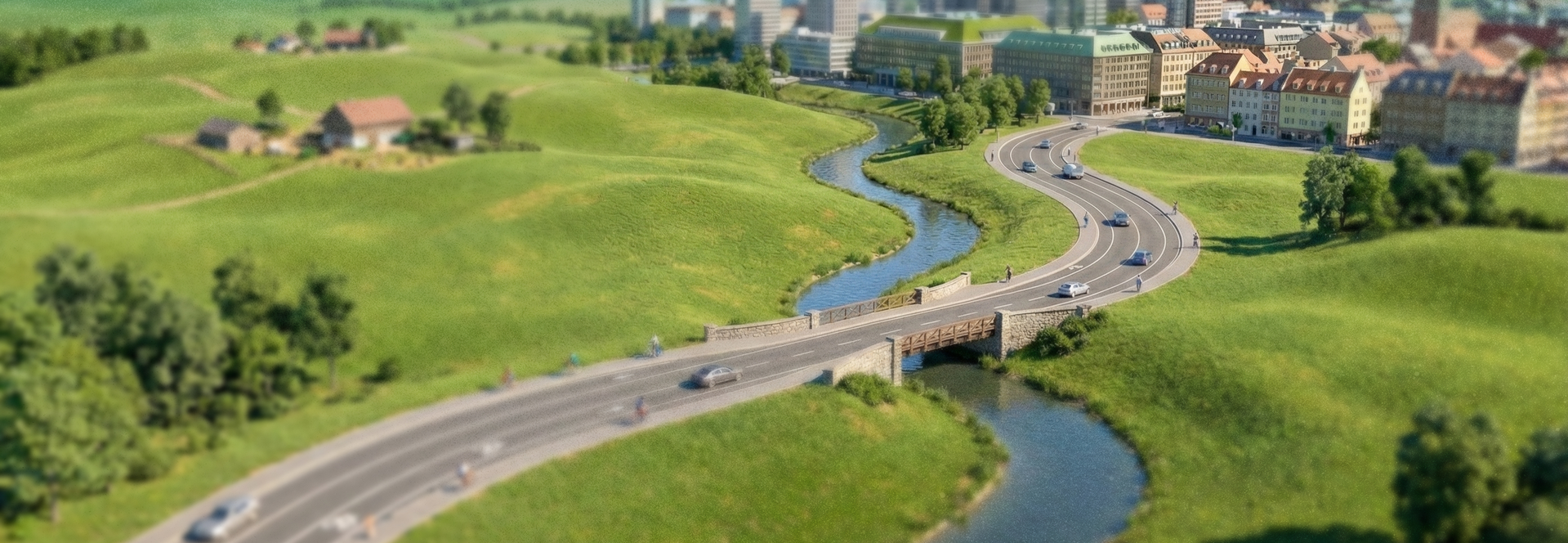 En väg som slingrar sig från landsbygden in mot en stad, en bild för resan från uppstart till lansering