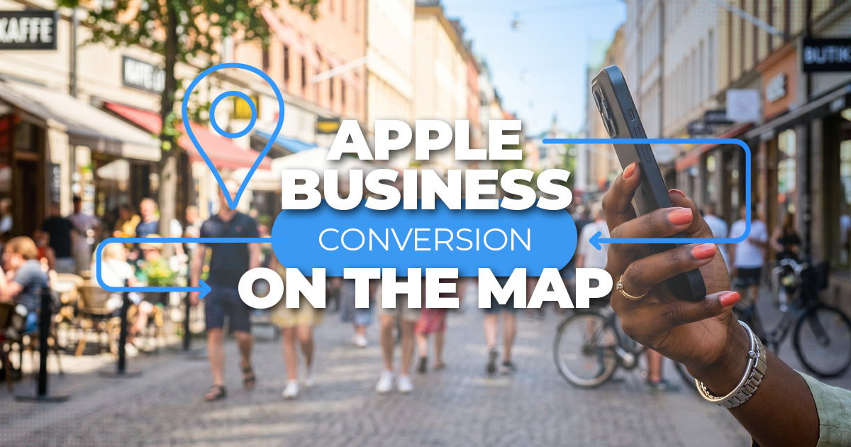 Person holding an iPhone on a busy shopping street — Apple Business conversion on the map for multi-location brands